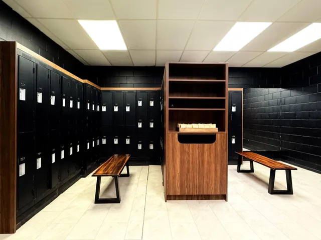 Open locker room with wood-toned lockers and benches