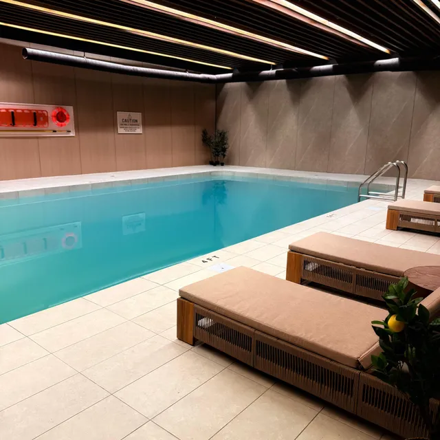Poolside loungers under warm ambient lighting